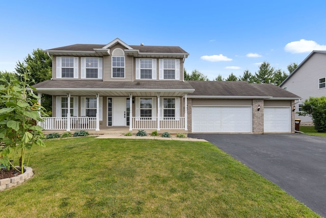 2225 National Sewing Ave, Belvidere, IL 61008 - colonial home with asphalt driveway, an attached garage, covered porch, and a front lawn