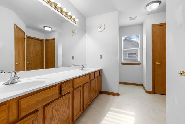 2225 National Sewing Ave, Belvidere, IL 61008 - bathroom featuring double vanity and baseboards