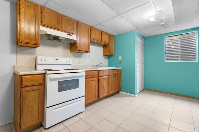 2225 National Sewing Ave, Belvidere, IL 61008 - kitchen with white range with electric stovetop, under cabinet range hood, light countertops, a drop ceiling, and brown cabinetry