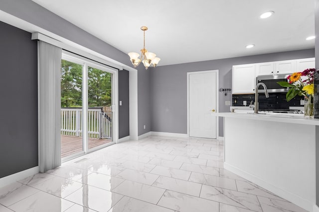 2225 National Sewing Ave, Belvidere, IL 61008 - unfurnished dining area with light marble finish floors, a chandelier, and recessed lighting