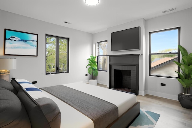 2305 W 111th Pl, Chicago, IL 60643 - bedroom featuring light wood-style floors and a fireplace