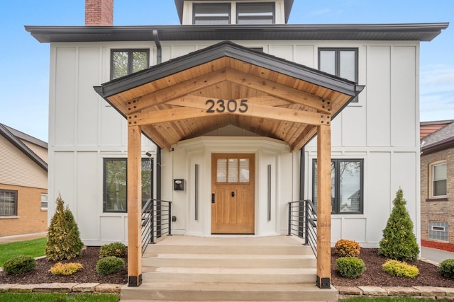2305 W 111th Pl, Chicago, IL 60643 - doorway to property featuring board and batten siding and a chimney