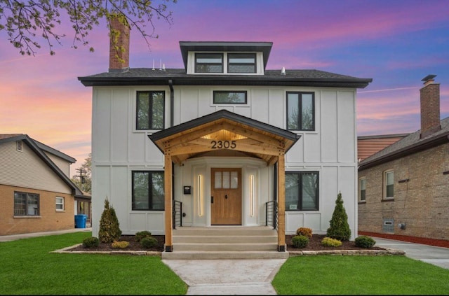 2305 W 111th Pl, Chicago, IL 60643 - view of front of house with board and batten siding, a yard, and a chimney