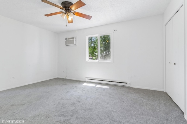 214 Madison St Unit 3A, Joliet, IL 60435 - empty room with baseboard heating, carpet, a wall mounted air conditioner, and ceiling fan