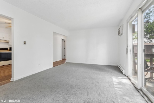 214 Madison St Unit 3A, Joliet, IL 60435 - unfurnished room with carpet floors, a baseboard heating unit, and a wall mounted air conditioner