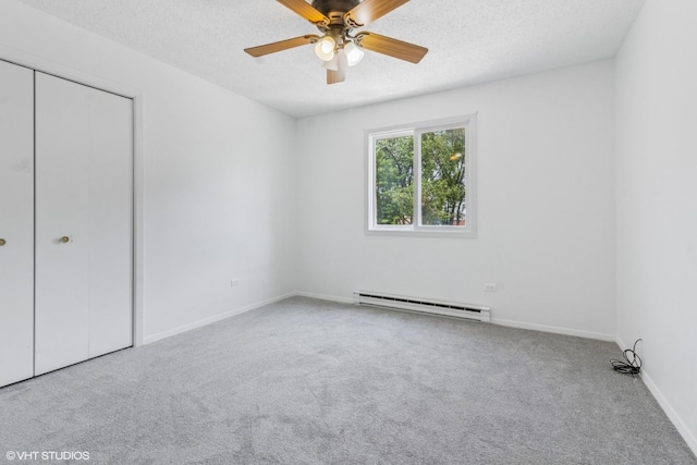 214 Madison St Unit 3A, Joliet, IL 60435 - unfurnished bedroom with a baseboard heating unit, carpet, a textured ceiling, a closet, and a ceiling fan
