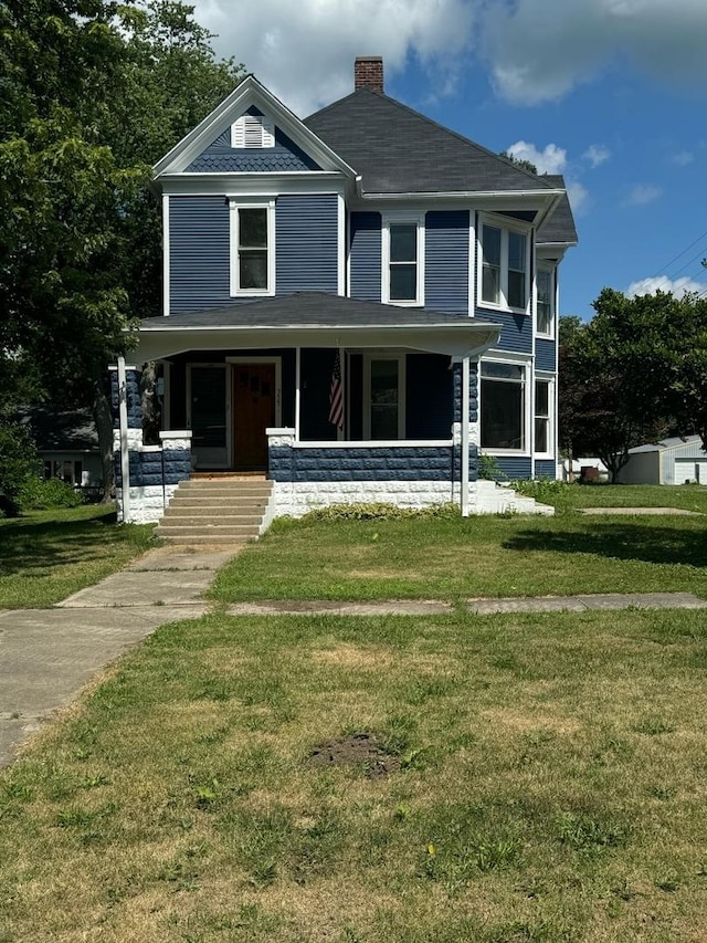 355 N 5th St, Sheldon, IL 60966 - view of front of home featuring a front yard, a chimney, a porch, and a shingled roof