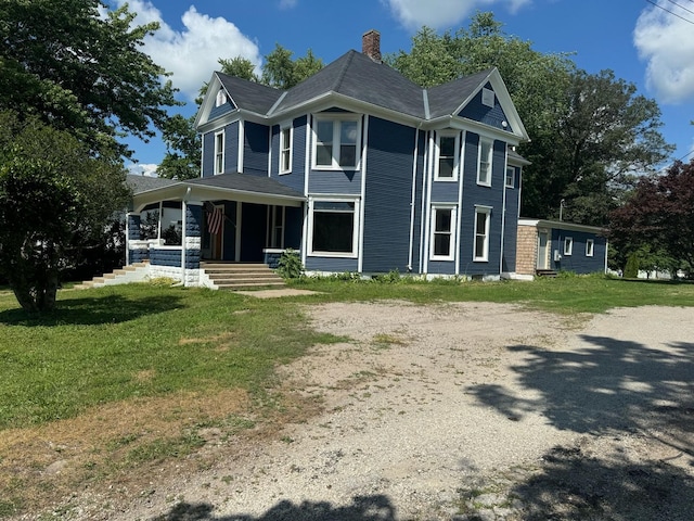 355 N 5th St, Sheldon, IL 60966 - view of front of home with a porch, a chimney, a front yard, and driveway