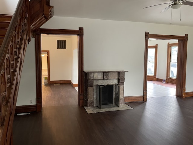 355 N 5th St, Sheldon, IL 60966 - unfurnished living room with a ceiling fan, wood finished floors, a stone fireplace, and stairway
