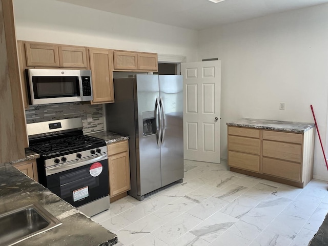 355 N 5th St, Sheldon, IL 60966 - kitchen with stainless steel appliances, light marble finish floors, decorative backsplash, and dark stone countertops