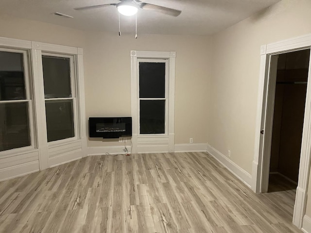 355 N 5th St, Sheldon, IL 60966 - unfurnished living room with heating unit, a ceiling fan, and light wood-style floors