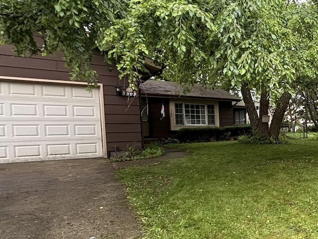 5305 Abbey Dr, Mchenry, IL 60050 - view of front of house with a garage, asphalt driveway, and a front yard
