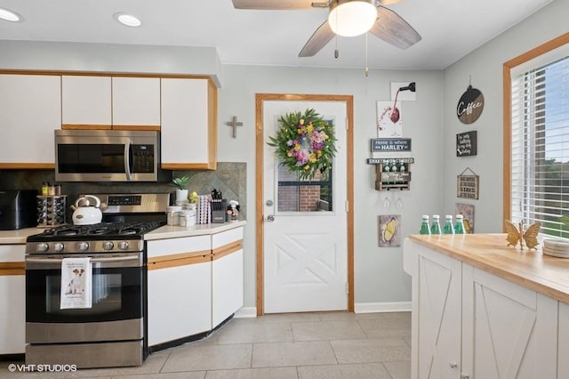 48 Parliament Dr W Unit 132, Palos Heights, IL 60463 - kitchen featuring appliances with stainless steel finishes, white cabinets, light countertops, backsplash, and ceiling fan