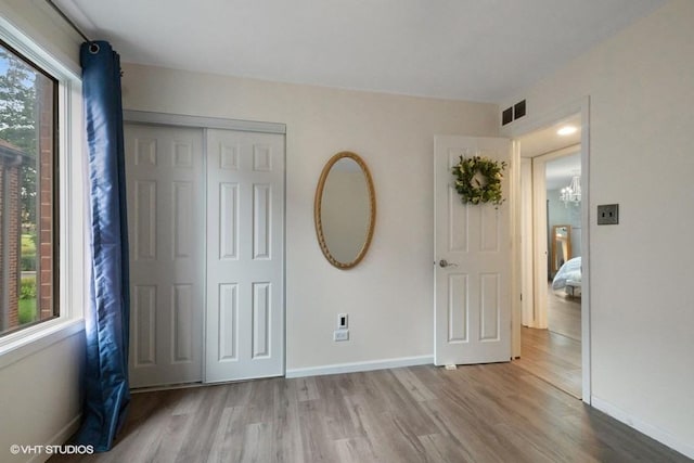 48 Parliament Dr W Unit 132, Palos Heights, IL 60463 - unfurnished bedroom with wood finished floors and a closet