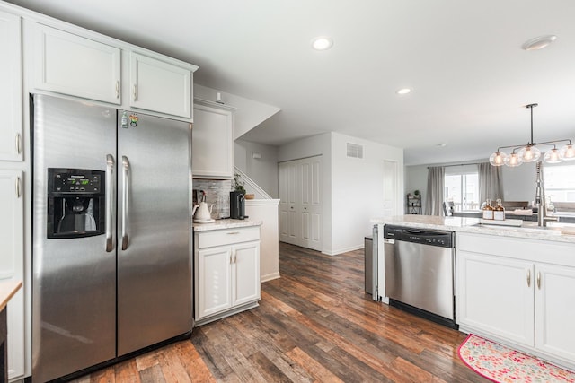 2366 Aurora Dr, Pingree Grove, IL 60140 - kitchen featuring appliances with stainless steel finishes, dark wood finished floors, recessed lighting, tasteful backsplash, and light stone counters