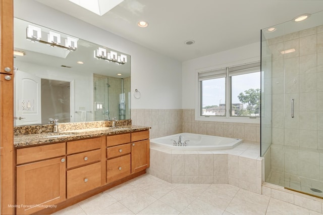 3129 N Oconto Ave, Chicago, IL 60707 - bathroom with tile patterned floors, double vanity, a bath, a stall shower, and recessed lighting