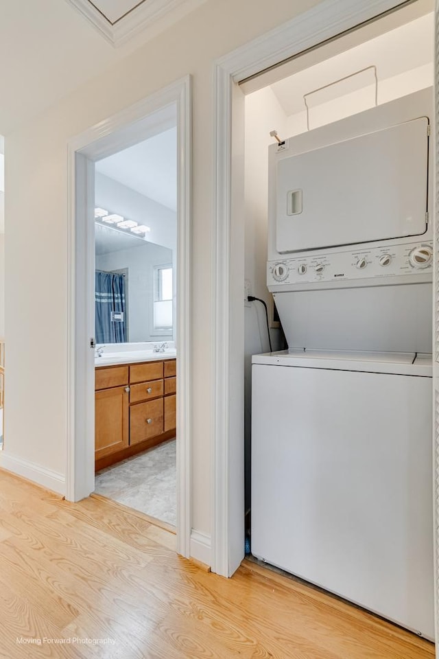 3129 N Oconto Ave, Chicago, IL 60707 - laundry area featuring estacked washer and dryer and light wood finished floors