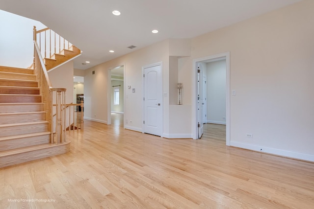 3129 N Oconto Ave, Chicago, IL 60707 - unfurnished living room with light wood-style flooring, stairway, and recessed lighting