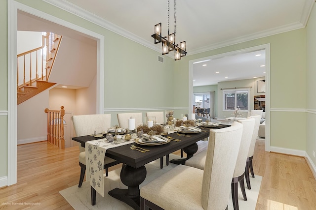 3129 N Oconto Ave, Chicago, IL 60707 - dining area with light wood finished floors, ornamental molding, stairway, a chandelier, and recessed lighting