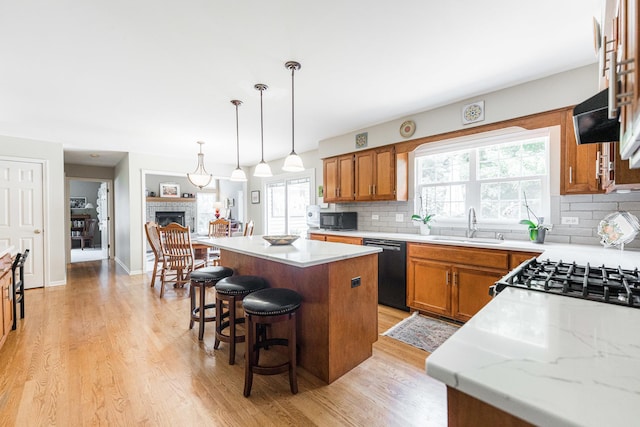 102 Quinlan Ave, Dekalb, IL 60115 - kitchen with dishwasher, a center island, backsplash, and brown cabinets
