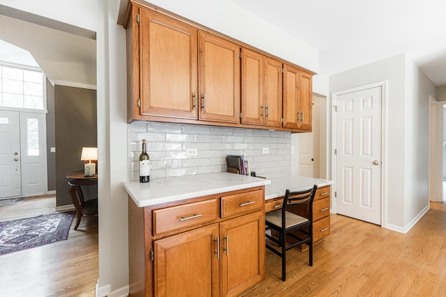 102 Quinlan Ave, Dekalb, IL 60115 - kitchen with light wood-style floors, light countertops, backsplash, and brown cabinets