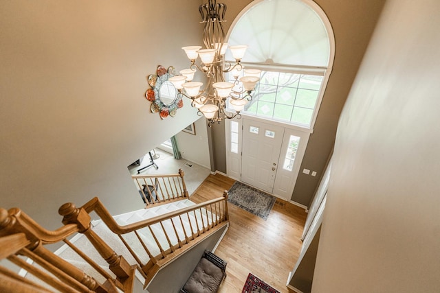 102 Quinlan Ave, Dekalb, IL 60115 - entryway with light wood-style flooring, a chandelier, and stairway
