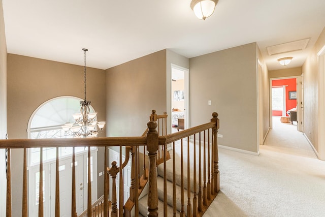 102 Quinlan Ave, Dekalb, IL 60115 - hall with an upstairs landing, light colored carpet, and a chandelier