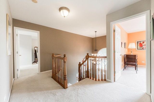 102 Quinlan Ave, Dekalb, IL 60115 - corridor with an upstairs landing, carpet flooring, and a chandelier