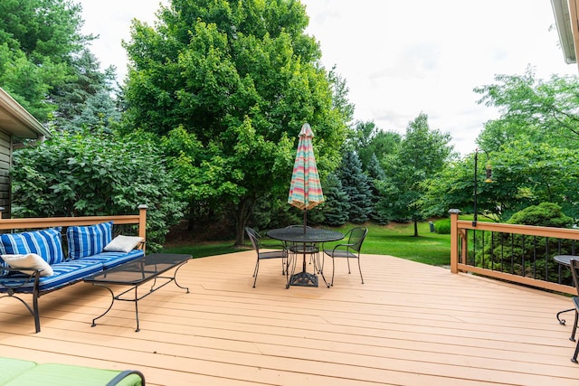 102 Quinlan Ave, Dekalb, IL 60115 - wooden deck with outdoor dining space, view of scattered trees, and an outdoor living space