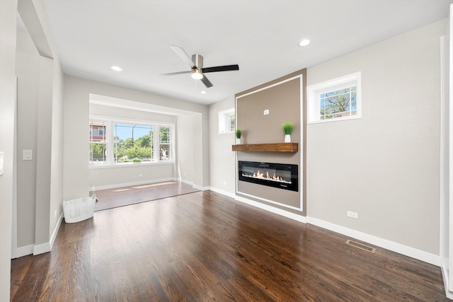 2101 S 48th Ct, Cicero, IL 60804 - unfurnished living room featuring wood finished floors, a glass covered fireplace, a ceiling fan, and recessed lighting