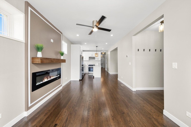 2101 S 48th Ct, Cicero, IL 60804 - unfurnished living room with a glass covered fireplace, dark wood-style flooring, ceiling fan, and recessed lighting