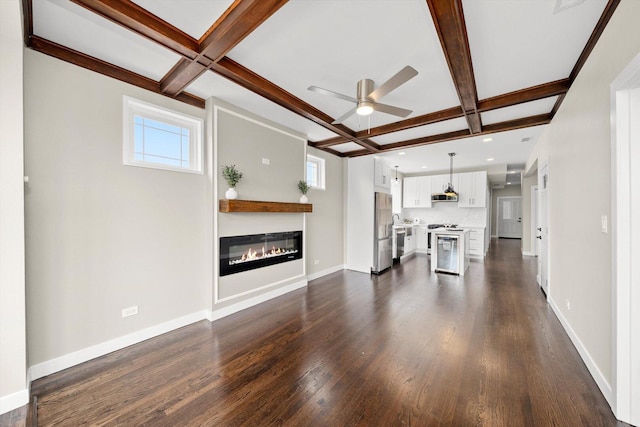 2101 S 48th Ct, Cicero, IL 60804 - unfurnished living room featuring coffered ceiling, ceiling fan, dark wood-type flooring, beam ceiling, and a glass covered fireplace