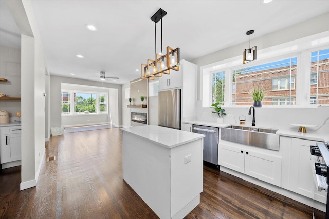 2101 S 48th Ct, Cicero, IL 60804 - kitchen with appliances with stainless steel finishes, ceiling fan, a kitchen island, recessed lighting, and dark wood-type flooring