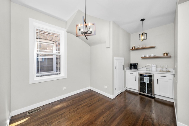 2101 S 48th Ct, Cicero, IL 60804 - indoor dry bar featuring beverage cooler, dark wood finished floors, a chandelier, vaulted ceiling, and pendant lighting
