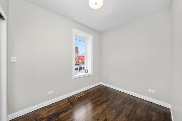 2101 S 48th Ct, Cicero, IL 60804 - spare room featuring baseboards and dark wood-style flooring
