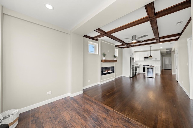 2101 S 48th Ct, Cicero, IL 60804 - unfurnished living room with coffered ceiling, dark wood-type flooring, a glass covered fireplace, ceiling fan, and beamed ceiling
