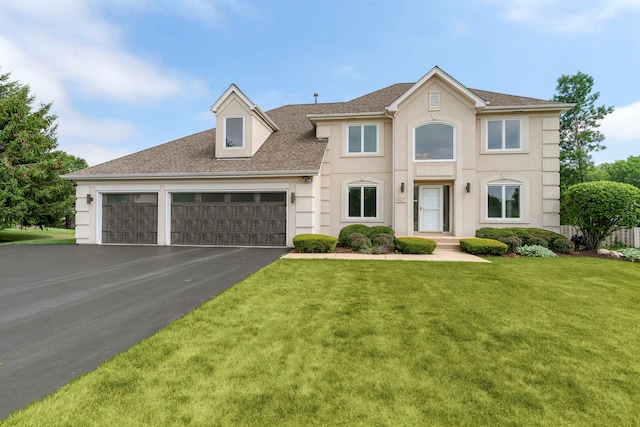 401 Kerry Ct, Prospect Heights, IL 60070 - view of front facade with driveway, a front yard, an attached garage, a shingled roof, and stucco siding