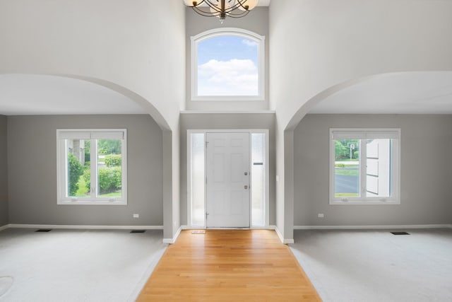 401 Kerry Ct, Prospect Heights, IL 60070 - foyer entrance with arched walkways, a high ceiling, and a chandelier