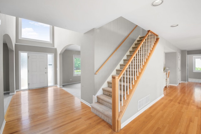 401 Kerry Ct, Prospect Heights, IL 60070 - foyer featuring arched walkways, light wood-type flooring, stairs, and recessed lighting