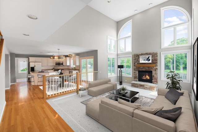 401 Kerry Ct, Prospect Heights, IL 60070 - living room with a towering ceiling, a fireplace, healthy amount of natural light, light wood-style floors, and recessed lighting