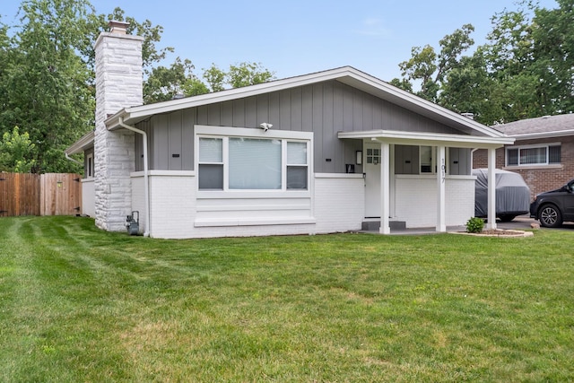 1017 Dell Rd, Northbrook, IL 60062 - view of front of house with a chimney, board and batten siding, and brick siding