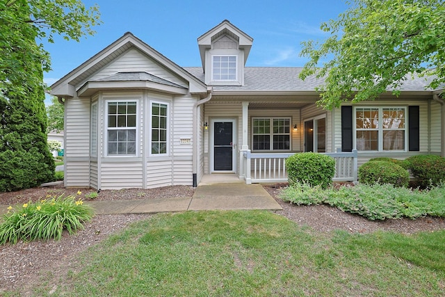12243 Quail Ridge Dr, Huntley, IL 60142 - view of front facade featuring a porch, a shingled roof, and a front yard