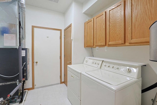 12243 Quail Ridge Dr, Huntley, IL 60142 - washroom featuring cabinet space, washer and dryer, light flooring, and heating unit