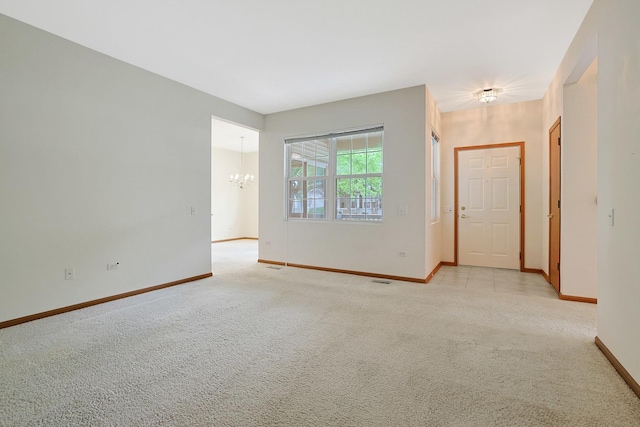 12243 Quail Ridge Dr, Huntley, IL 60142 - spare room with a chandelier and light carpet