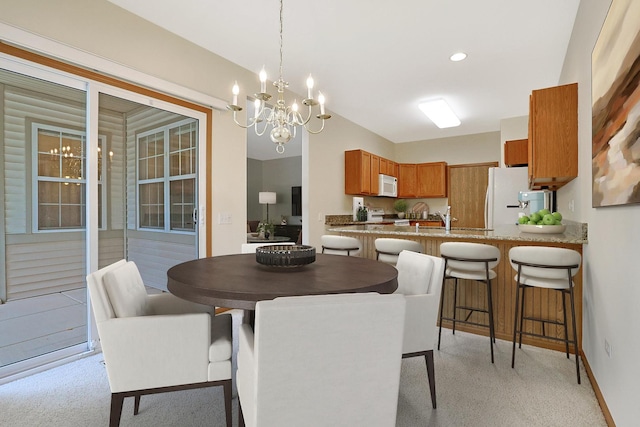 12243 Quail Ridge Dr, Huntley, IL 60142 - dining room with a chandelier and light colored carpet