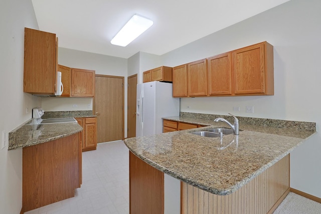 12243 Quail Ridge Dr, Huntley, IL 60142 - kitchen with white appliances, a peninsula, stone counters, and brown cabinetry