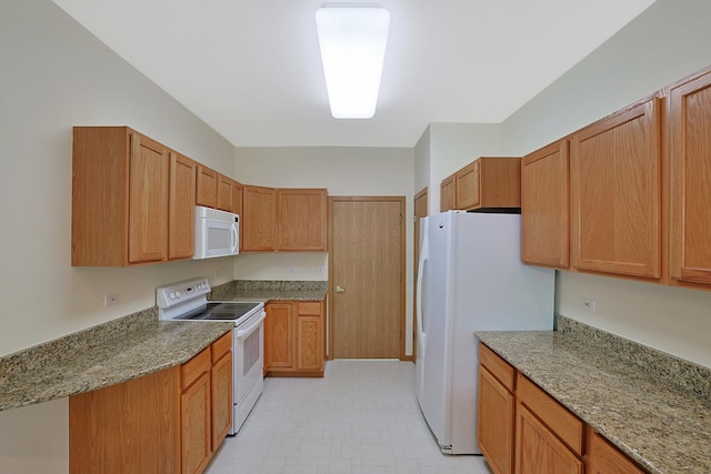12243 Quail Ridge Dr, Huntley, IL 60142 - kitchen with white appliances, light stone counters, and light flooring