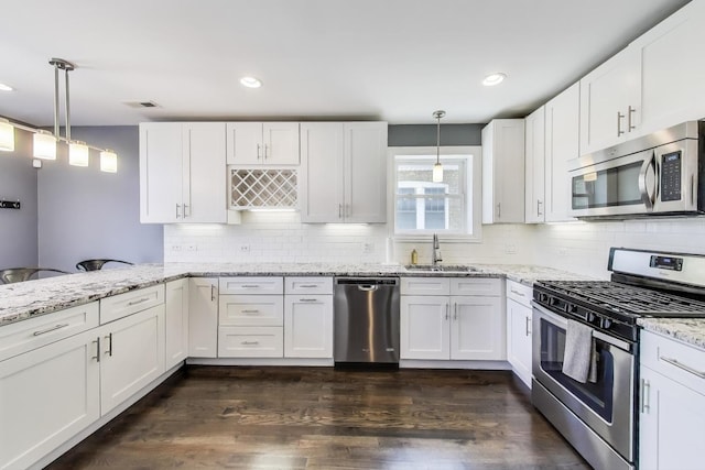 5921 N Navarre Ave, Chicago, IL 60631 - kitchen featuring stainless steel appliances, white cabinets, light stone counters, dark wood-style flooring, and backsplash