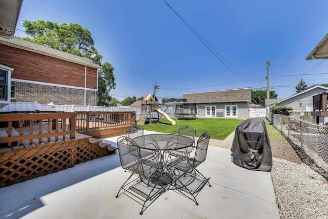 5921 N Navarre Ave, Chicago, IL 60631 - fenced backyard featuring a playground, outdoor dining area, a patio area, and a wooden deck