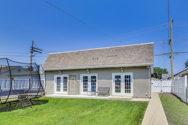 5921 N Navarre Ave, Chicago, IL 60631 - back of house featuring french doors, a shingled roof, a fenced backyard, and a trampoline